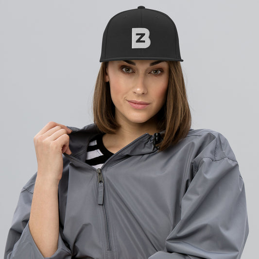 Front view of Bazooka Zook black snapback hat worn by a female model